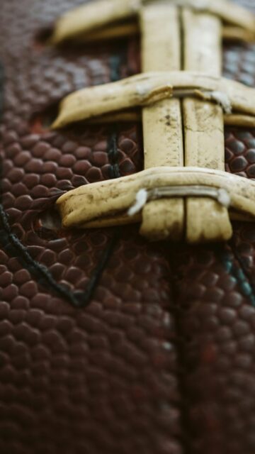 Macro Close-Up of American Football Laces Texture Phone Wallpaper