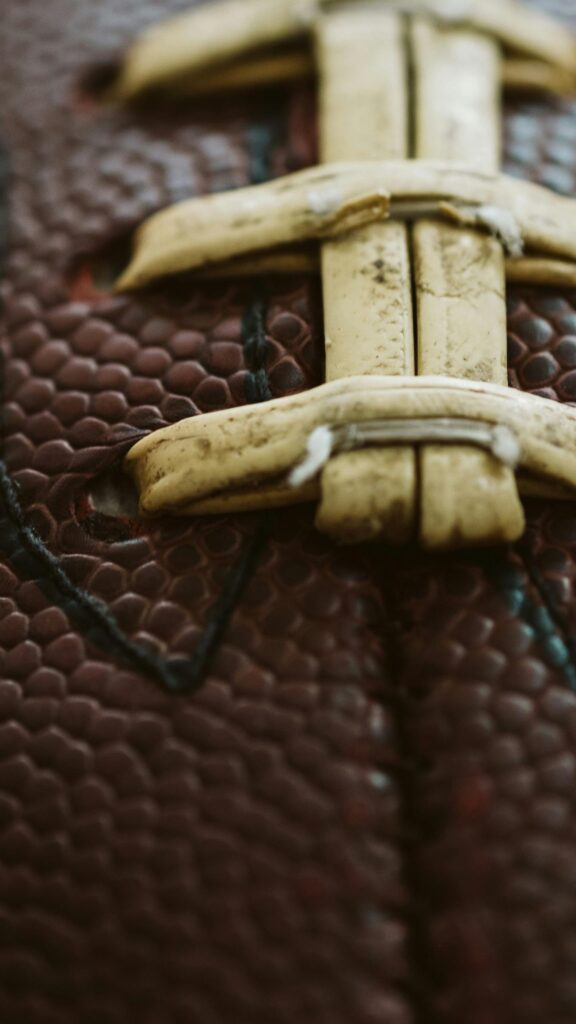 Macro Close-Up of American Football Laces Texture Phone Wallpaper