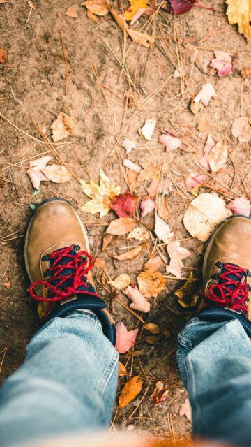 First-Person POV Hiking Boots on Autumn Trail Fall Season Wallpaper