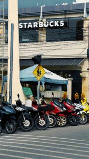 Vibrant Row of Motorcycles Parked at Thailand Starbucks Wallpaper