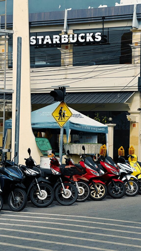 Vibrant Row of Motorcycles Parked at Thailand Starbucks Wallpaper