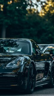 Sleek Black Porsche 718 Cayman Sportscar Mobile Wallpaper