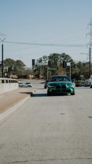 Stunning Green BMW M3 G80 Sports Car Road Intersection Wallpaper