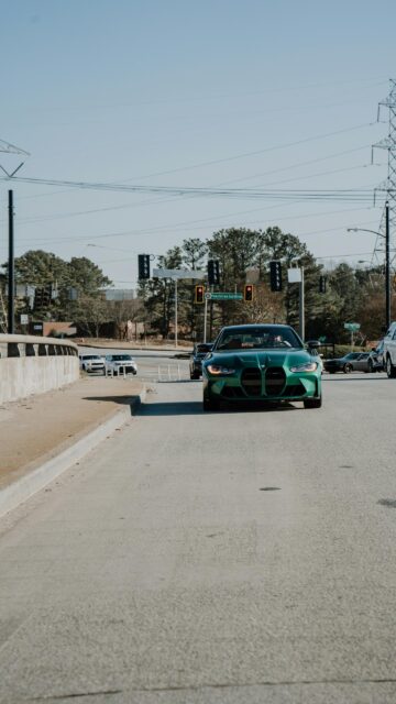 Stunning Green BMW M3 G80 Sports Car Road Intersection Wallpaper