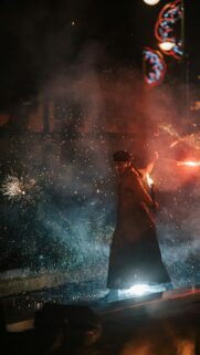 Fiery Street Performer with Sparks and Light Trails Mobile Wallpaper