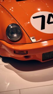 Vibrant Orange Vintage Racing Sports Car Front View Wallpaper