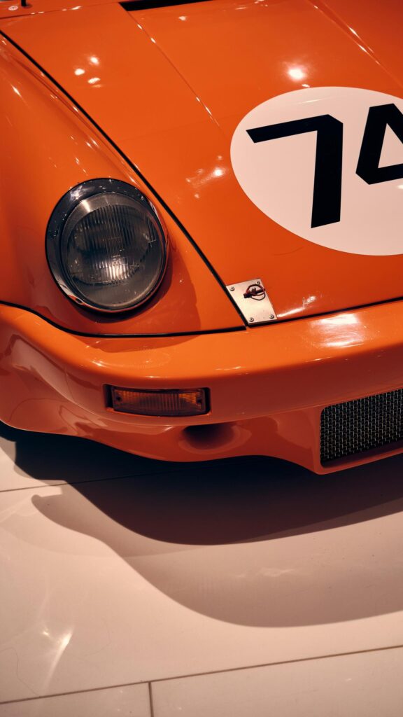 Vibrant Orange Vintage Racing Sports Car Front View Wallpaper