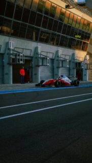 Formula 3 Race Car Waiting in Pit Lane at Sunset Wallpaper
