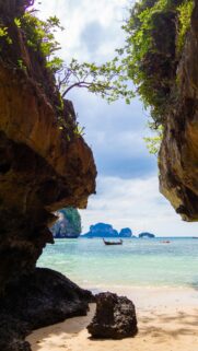 Tropical Island Beach Cave View with Longtail Boat Mobile Wallpaper