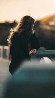 Pensive Woman at Sunset Aesthetic Phone Wallpaper