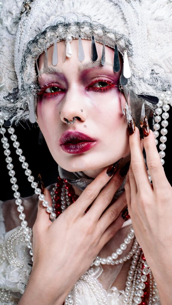 Stunning Avant-Garde Beauty with Silver Headpiece and Pearls Wallpaper