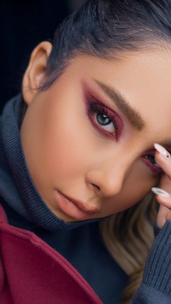 Stunning Close-Up Portrait of Woman with Red Makeup Mobile Wallpaper