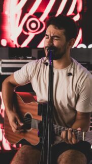 Singer Playing Acoustic Guitar Live Performance Phone Wallpaper