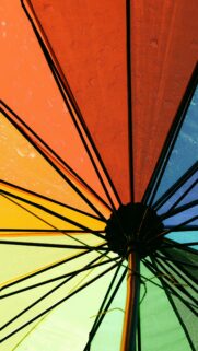Vibrant Rainbow Umbrella Under the Sun Mobile Phone Wallpaper