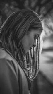 Emotional Portrait of a Girl with Backlit Hair Black and White Wallpaper