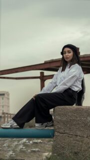 Stylish Woman in Minimalist Urban Outfit Phone Wallpaper