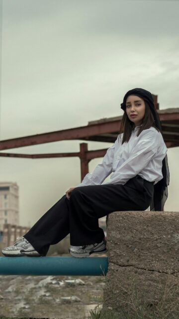 Stylish Woman in Minimalist Urban Outfit Phone Wallpaper