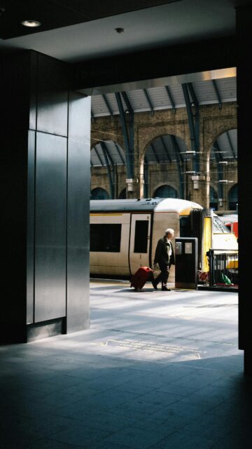 Lonely Traveler at Train Station Platform High Quality Wallpaper