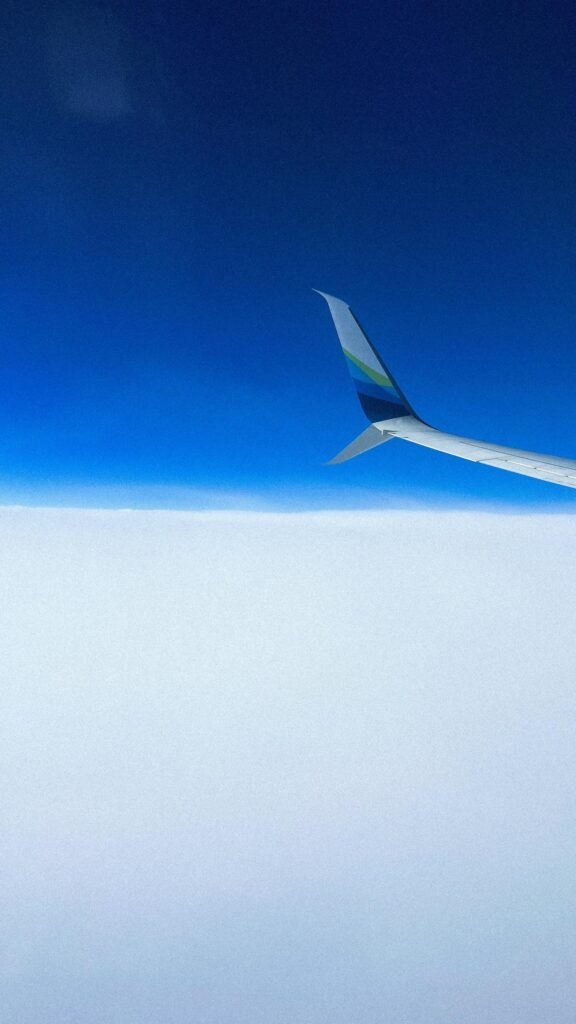 Minimalist Airplane Wing Above Cloud Sea and Deep Blue Sky Wallpaper