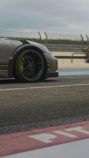 Grey Porsche Racing Car with Neon Accents Mobile Wallpaper