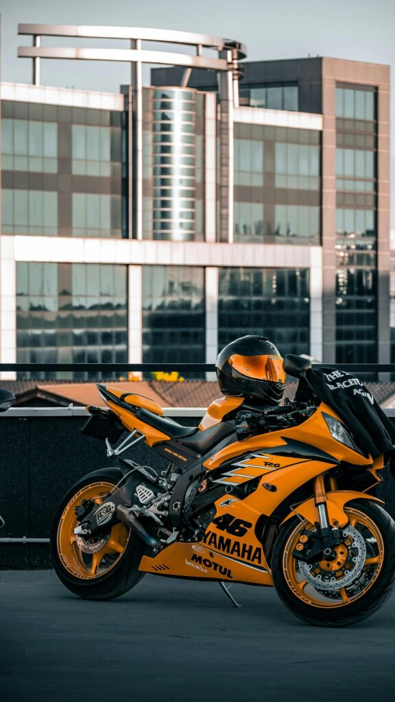 Stunning Yellow Yamaha R6 Sportbike with Helmet Mobile Wallpaper