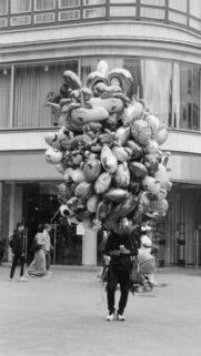 Street Vendor Carrying Massive Bunch of Foil Balloons Monochrome Wallpaper