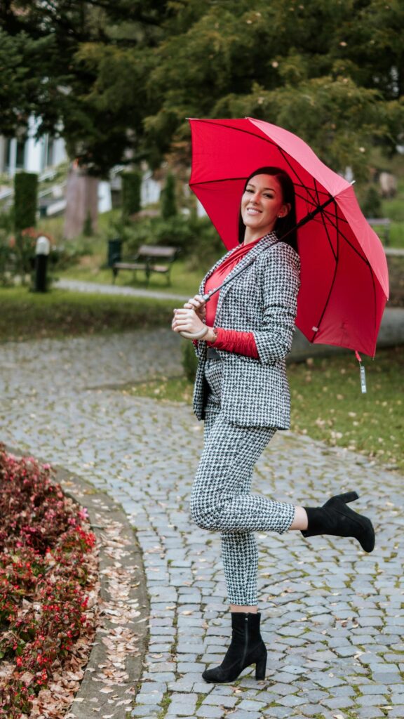 Stylish Woman with Red Umbrella in Houndstooth Suit Mobile Wallpaper