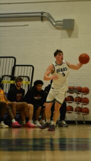 Intense Basketball Player Dribbling the Ball Action Shot Wallpaper