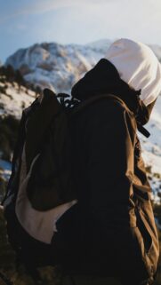 Adventurous Hiker in Snowy Mountains Mobile Phone Wallpaper