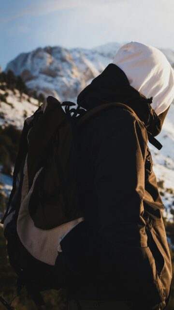 Adventurous Hiker in Snowy Mountains Mobile Phone Wallpaper