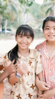 Cheerful Asian Best Friends Smiling Outdoors Mobile Wallpaper