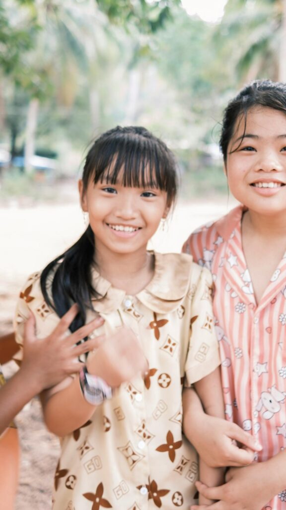 Cheerful Asian Best Friends Smiling Outdoors Mobile Wallpaper
