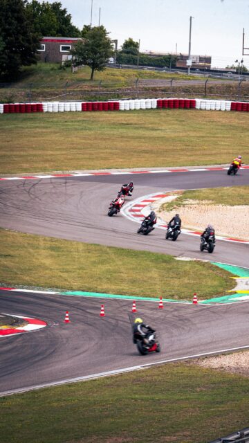 Thrilling High-Speed Motorcycle Road Race Action Mobile Wallpaper