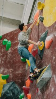Determined Rock Climber Ascending Indoor Wall Mobile Wallpaper