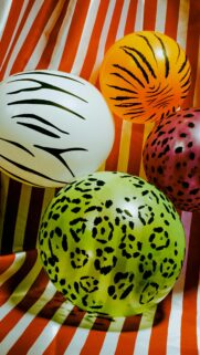 Vibrant Animal Print Balloons on Striped Background Mobile Wallpaper