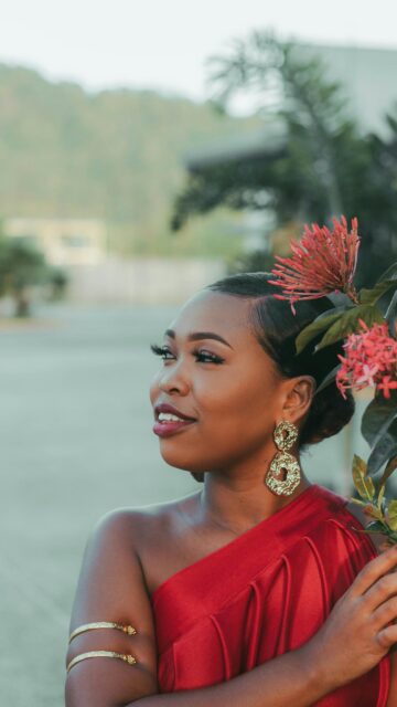 Elegant Woman in Red Satin Dress with Tropical Flowers Wallpaper