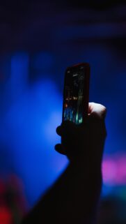 A Person Recording a Concert on Their Smartphone Mobile Wallpaper