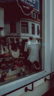 Charming Boutique Window Display with Jewelry and Apparel Wallpaper