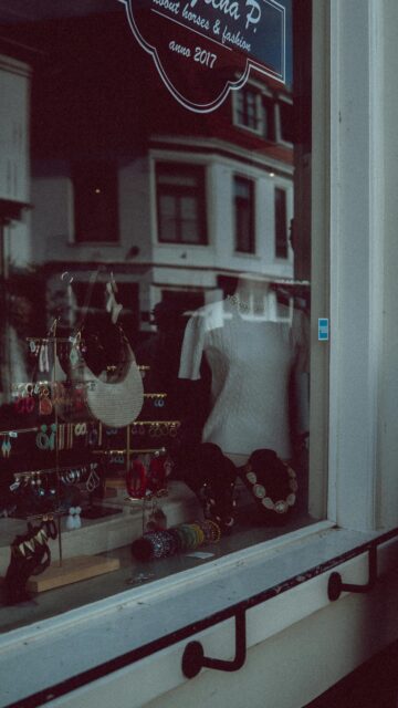 Charming Boutique Window Display with Jewelry and Apparel Wallpaper