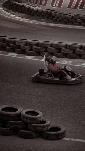 Dynamic Go-Kart Racing Speed on Track Mobile Phone Wallpaper