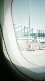 Airplane Window View of Sunny Airport Terminal Tarmac Wallpaper