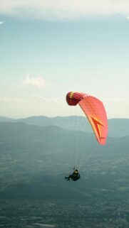 Stunning Paraglider Soaring Over Mountain Valley HD Wallpaper