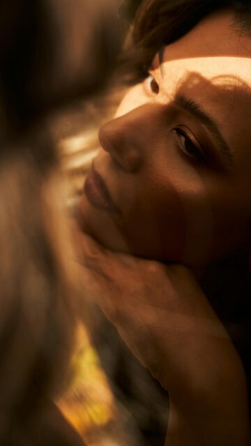 Dreamy Woman Portrait with Soft Sunlight Effects Mobile Wallpaper