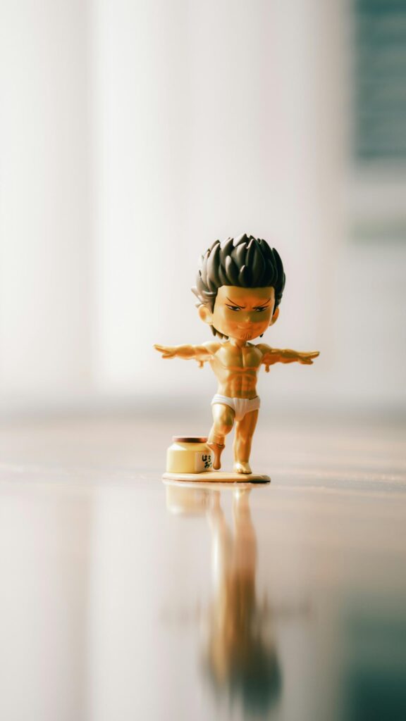 Golden Chibi Anime Character Figure Balancing on Honey Jar Wallpaper