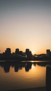 Stunning Sunset Cityscape Over Water Silhouette Mobile Wallpaper