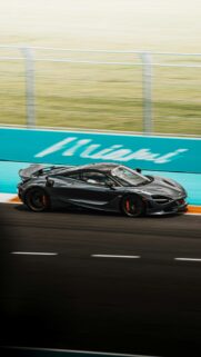 Grey McLaren 720S Speeding on Miami F1 Racetrack Mobile Wallpaper
