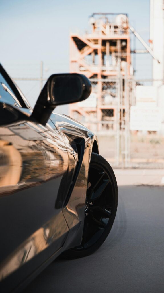 Sleek Black Sports Car Fender and Wheel Industrial Aesthetic Wallpaper