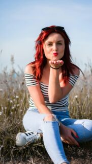 Beautiful Redhead Girl Blowing a Kiss Outdoor Phone Wallpaper