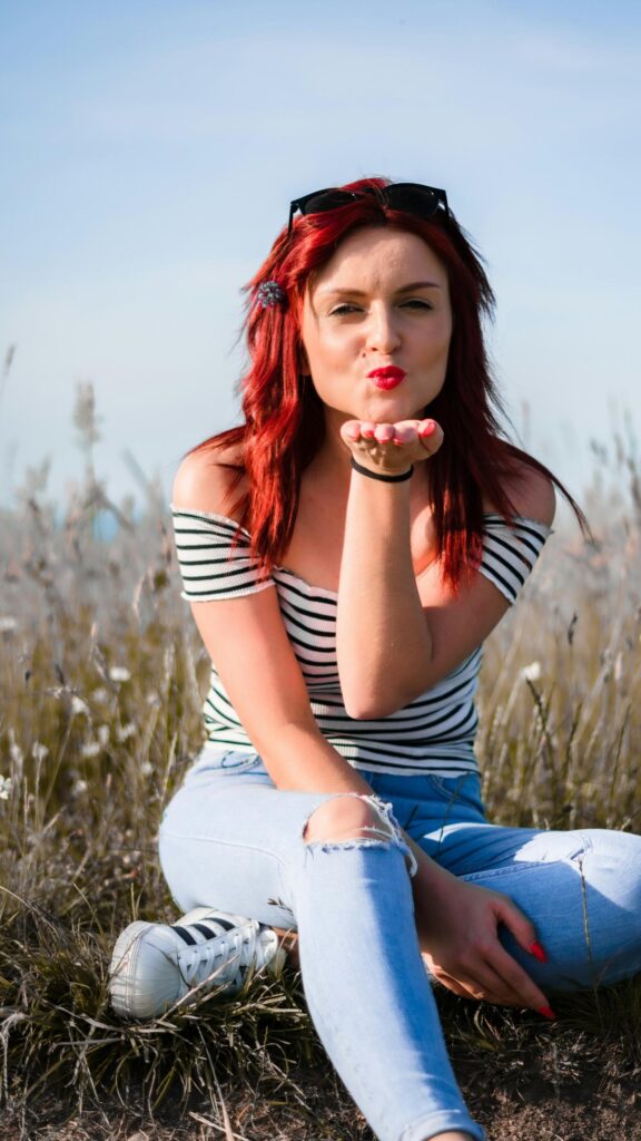 Beautiful Redhead Girl Blowing a Kiss Outdoor Phone Wallpaper