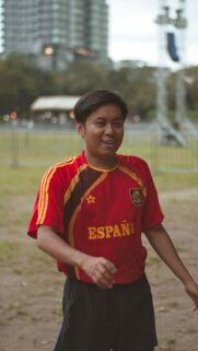 Smiling Young Man in Spain Soccer Jersey Portrait Mobile Wallpaper